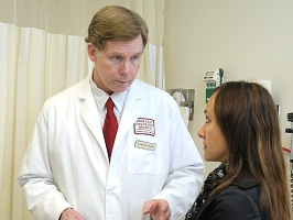 Marston Linehan, M.D., discusses treatment with a patient.