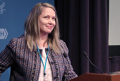 Dr. Terri Armstrong speaking at a podium