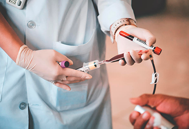 Nurse taking blood from patient