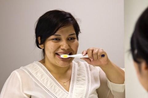 woman brushing her teeth