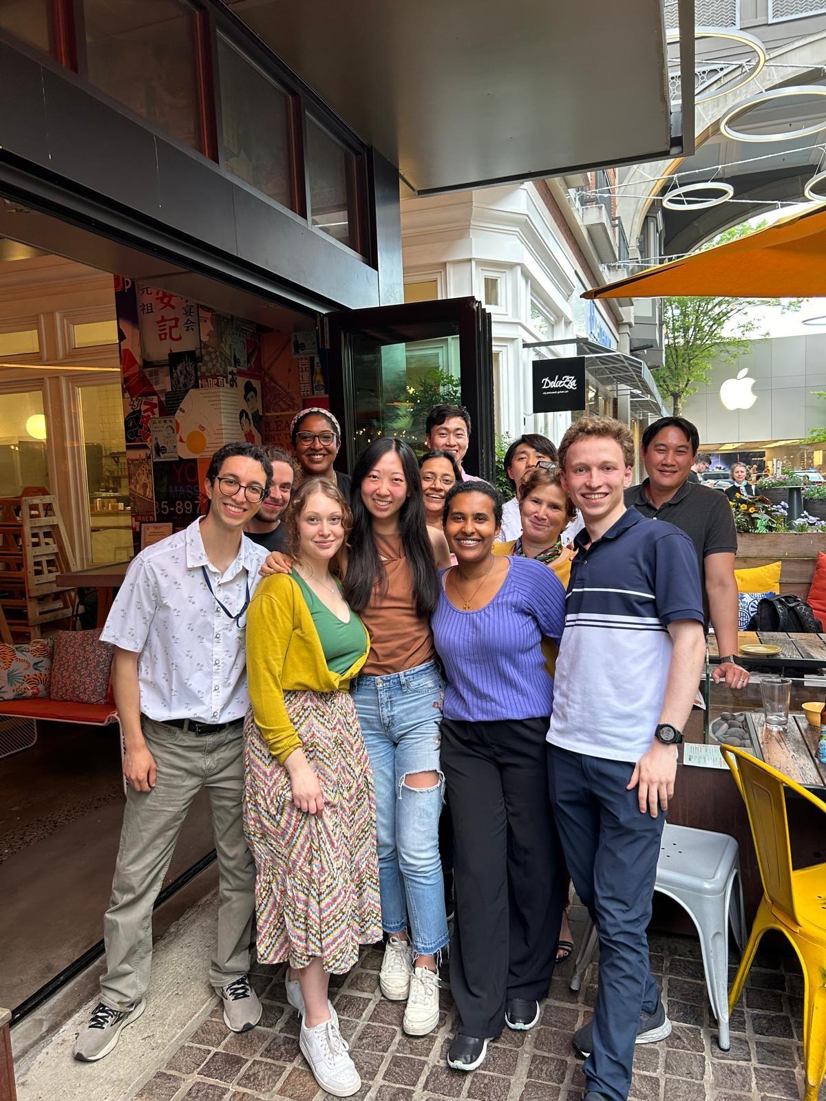 The group poses at a restaurant