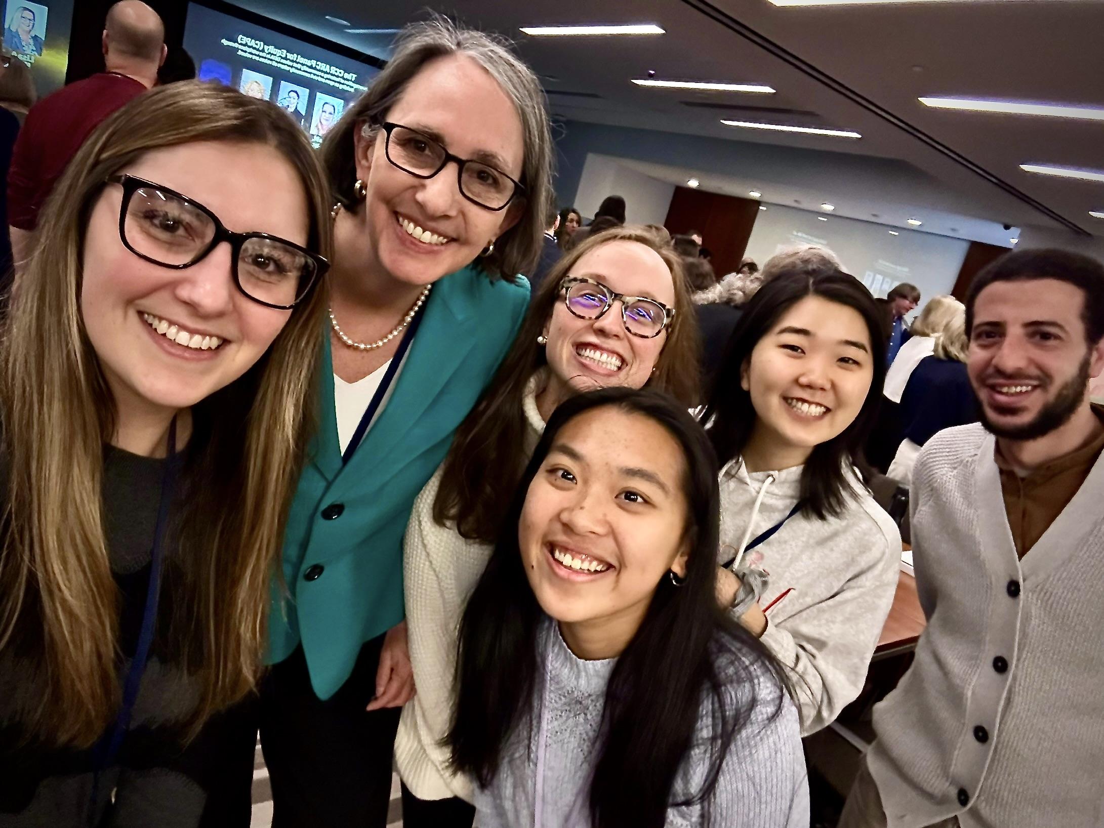 A group of trainees poses with the NCI Director, Dr. Kim Rathmell 